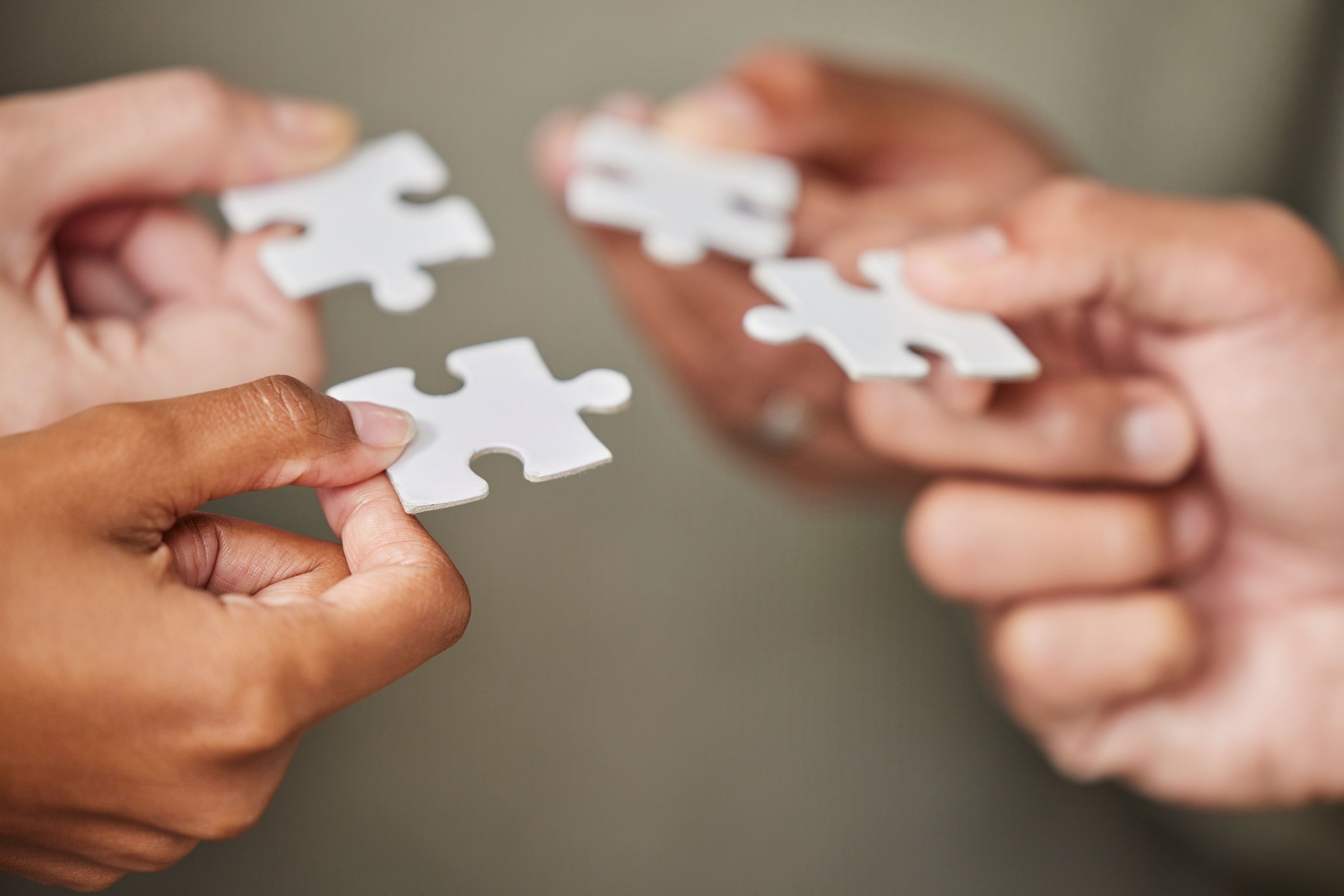 business-people-hands-and-puzzle